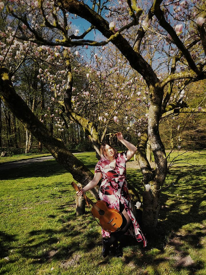 Spring girl with guitar